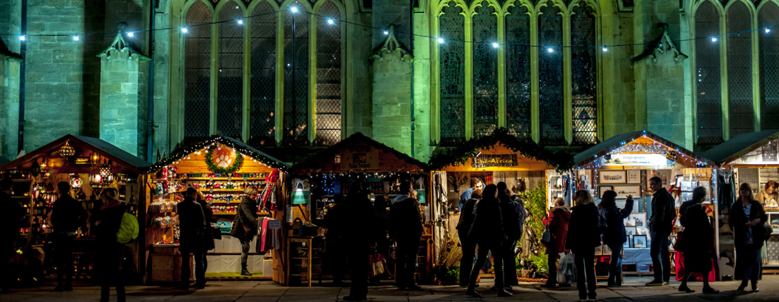 A row of chalets in front of Bath Abbey 