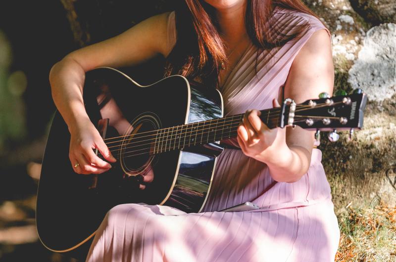 Justyna playing a guitar