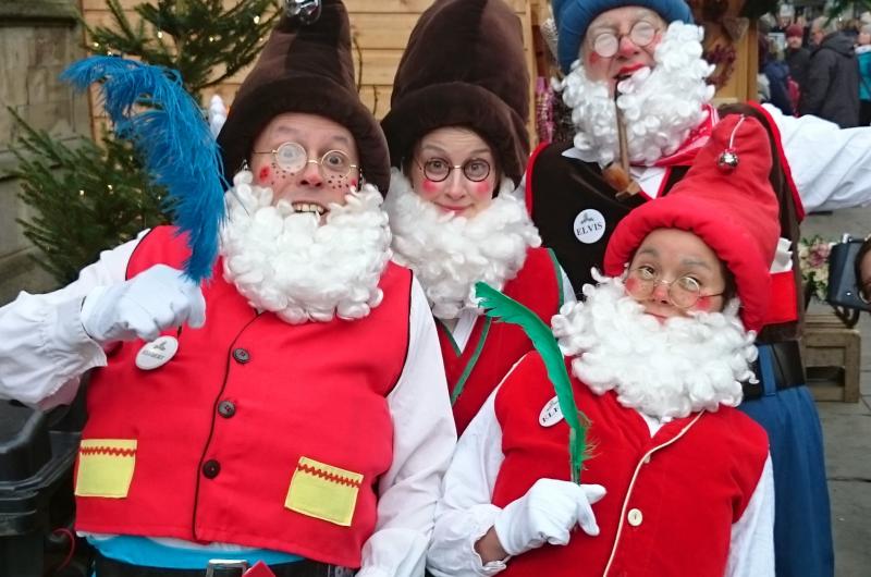 four elves pulling a funny face at christmas market