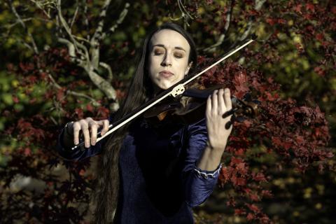 Miranda playing a violin