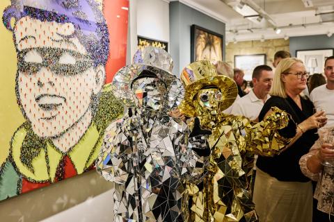 two men dressed in gold and silver mirror material suits