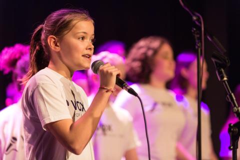 Girl singing into microphone