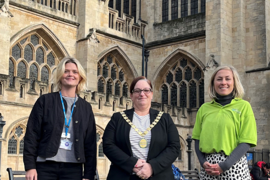 representatives from RUHX, GWAAC and B&NES council stand in front of Bath Abbey