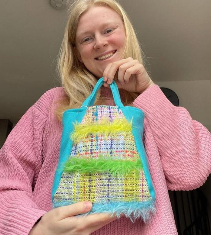 Woman holding vibrant fabric bag