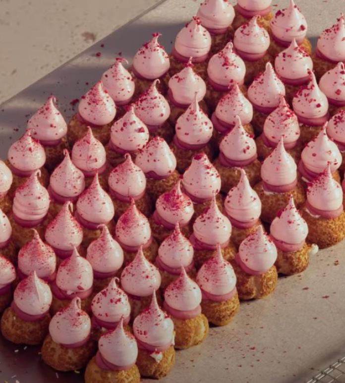 Small choux buns with pink icing