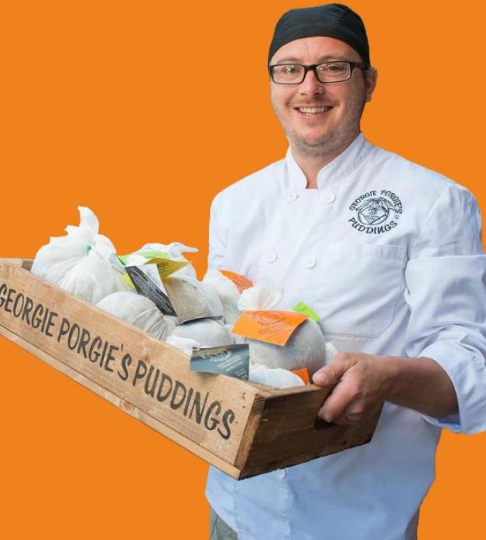 A man holding some Christmas Puddings