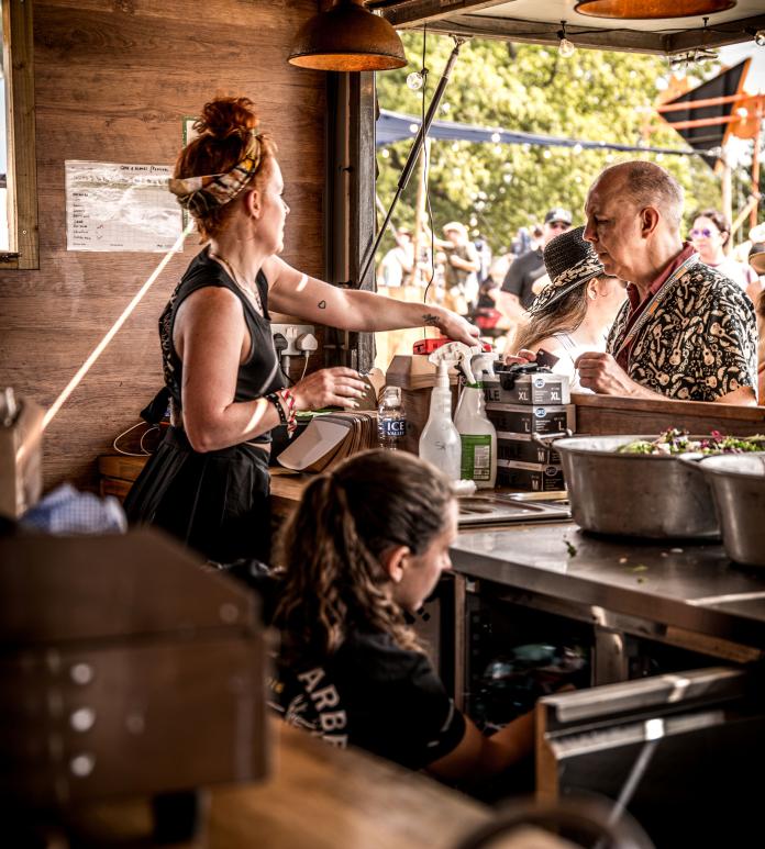 Lady serving food over a counter