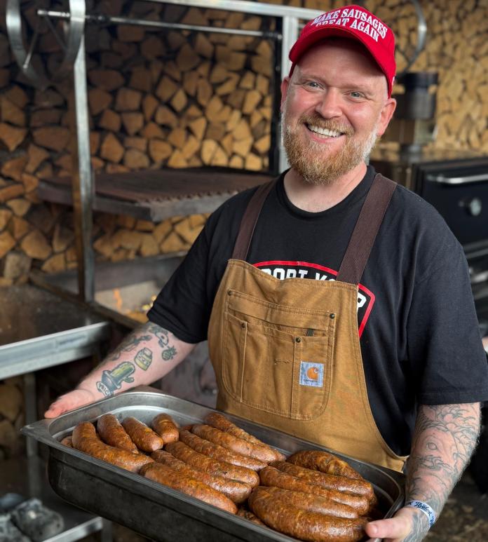 Man with tray of sausages