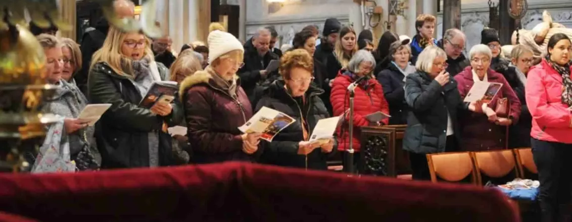 people singing carols in a church