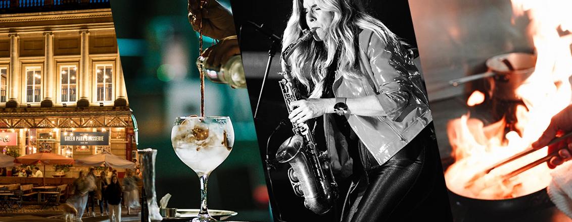 A Resturant in the evening, A glass of Wine, A Woman playing the saxophone and some flames in a hot pan. 