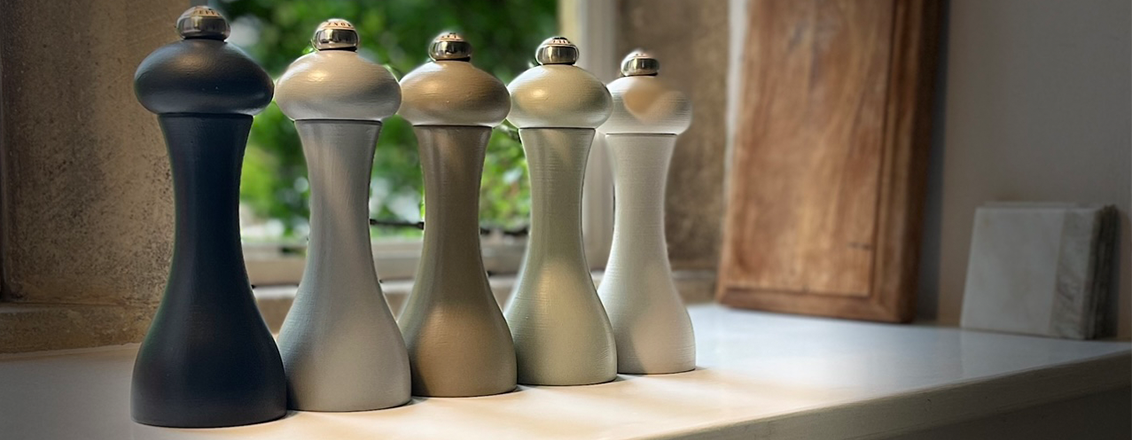 five pepper mills in an assortment of wooden shades