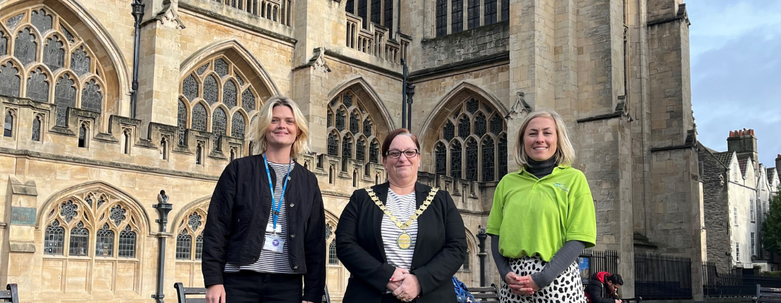 representatives from RUHX, GWAAC and B&NES council stand in front of Bath Abbey